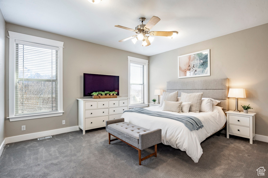 Bedroom featuring baseboards, carpet floors, and ceiling fan