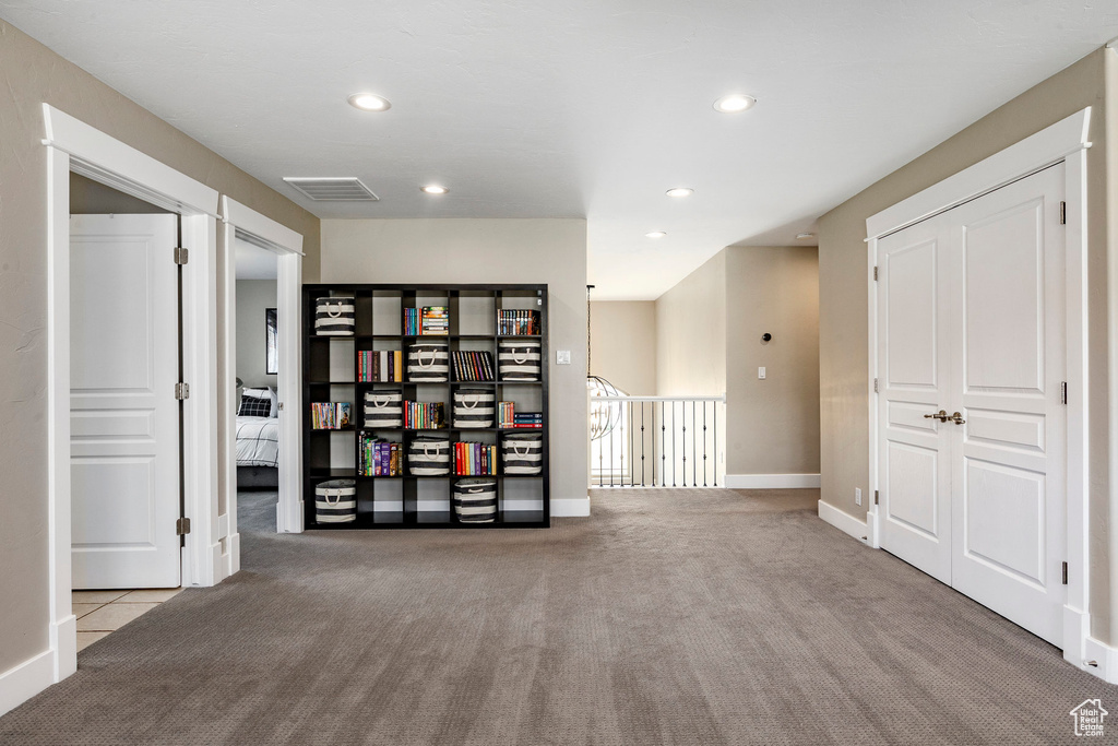 Carpeted spare room featuring recessed lighting and baseboards