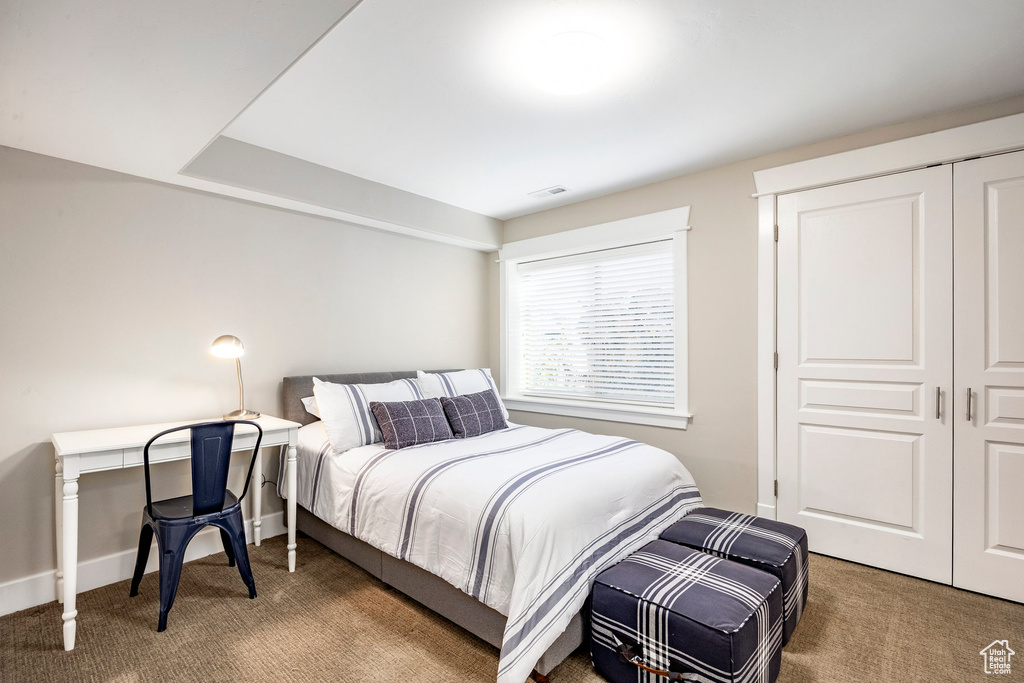 Bedroom featuring carpet, baseboards, and a closet