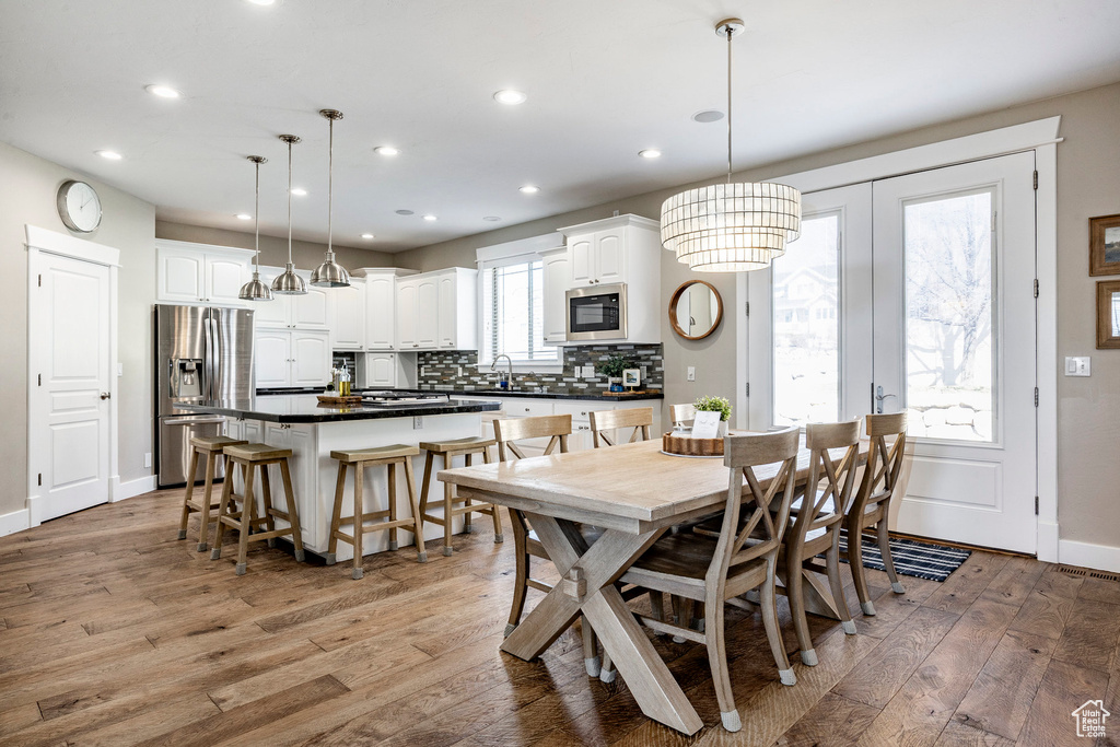 Dining space featuring light wood finished floors, recessed lighting, and baseboards