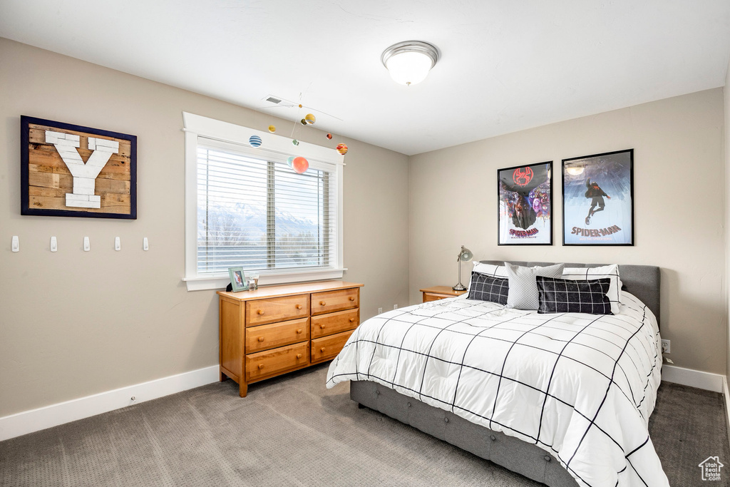 Bedroom featuring light colored carpet and baseboards