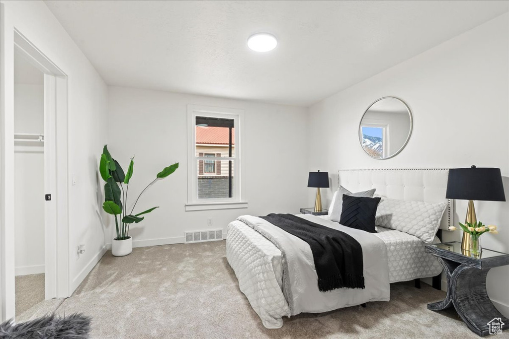 Bedroom featuring visible vents, carpet flooring, and baseboards