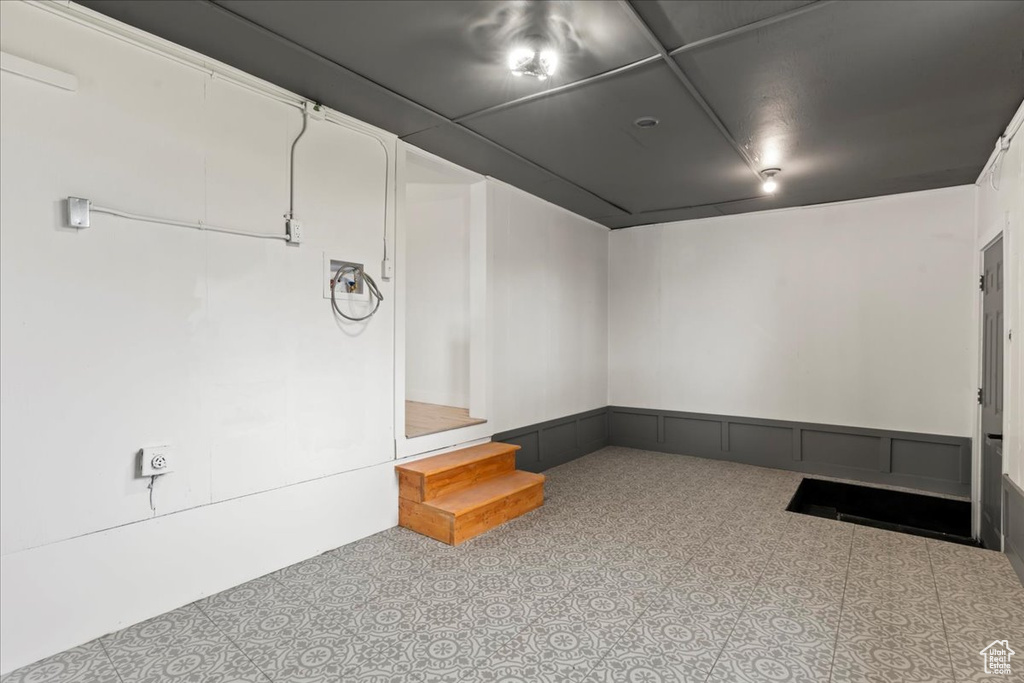 Basement featuring a wainscoted wall