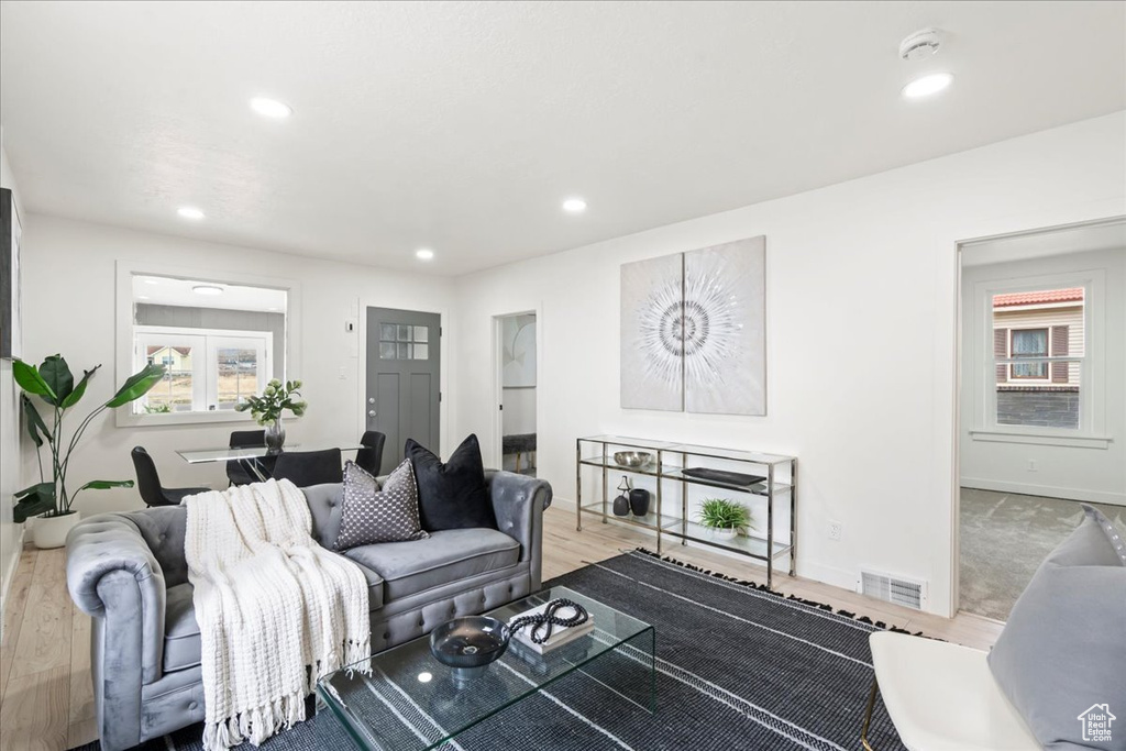 Living room featuring recessed lighting, wood finished floors, visible vents, and baseboards