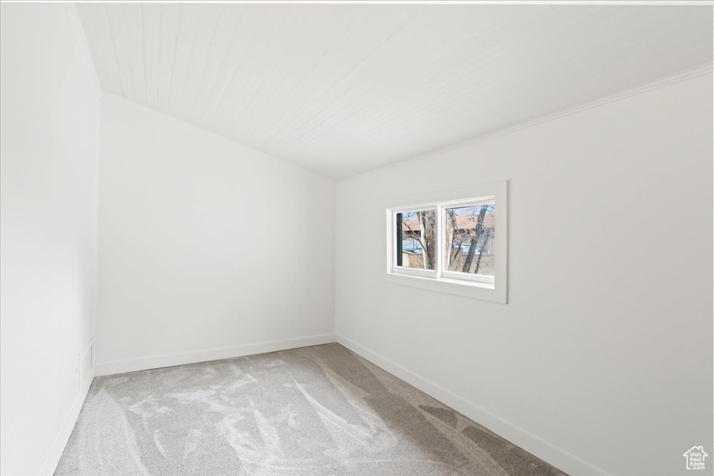 Empty room with baseboards and carpet