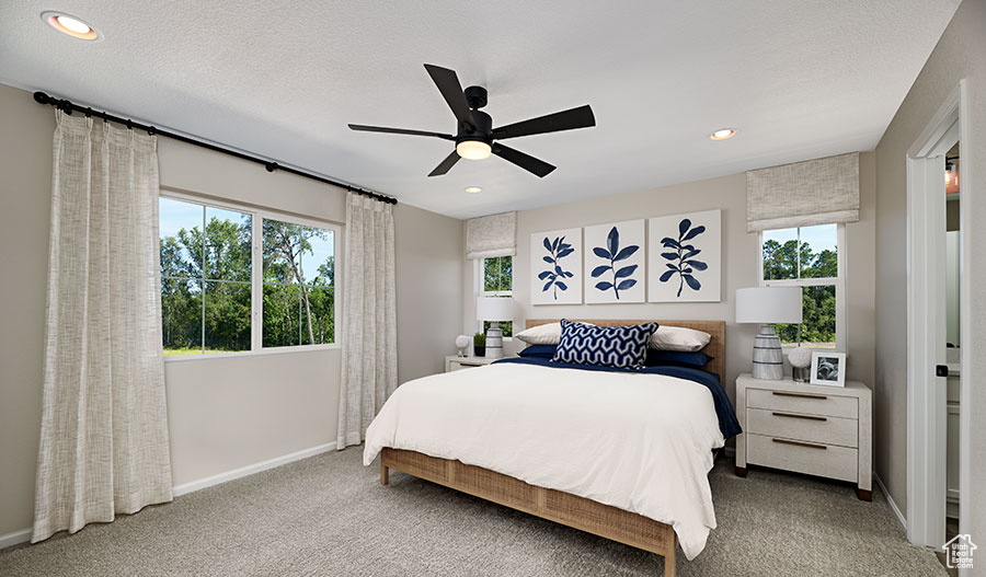 Carpeted bedroom with a ceiling fan, recessed lighting, baseboards, and a textured ceiling