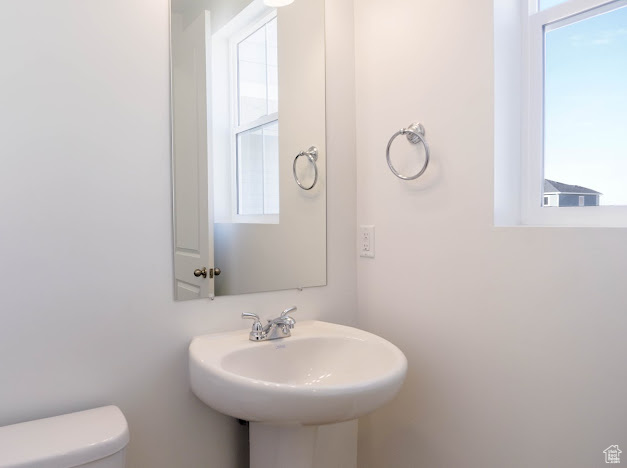 Half bathroom with toilet and a sink