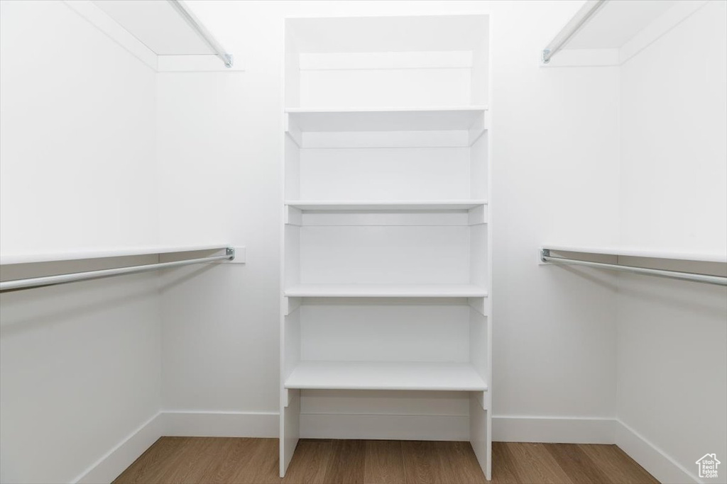 Spacious closet featuring wood finished floors
