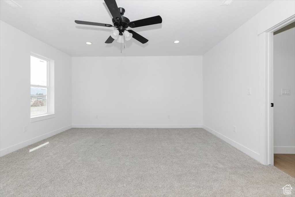 Unfurnished room featuring recessed lighting, ceiling fan, light colored carpet, and baseboards