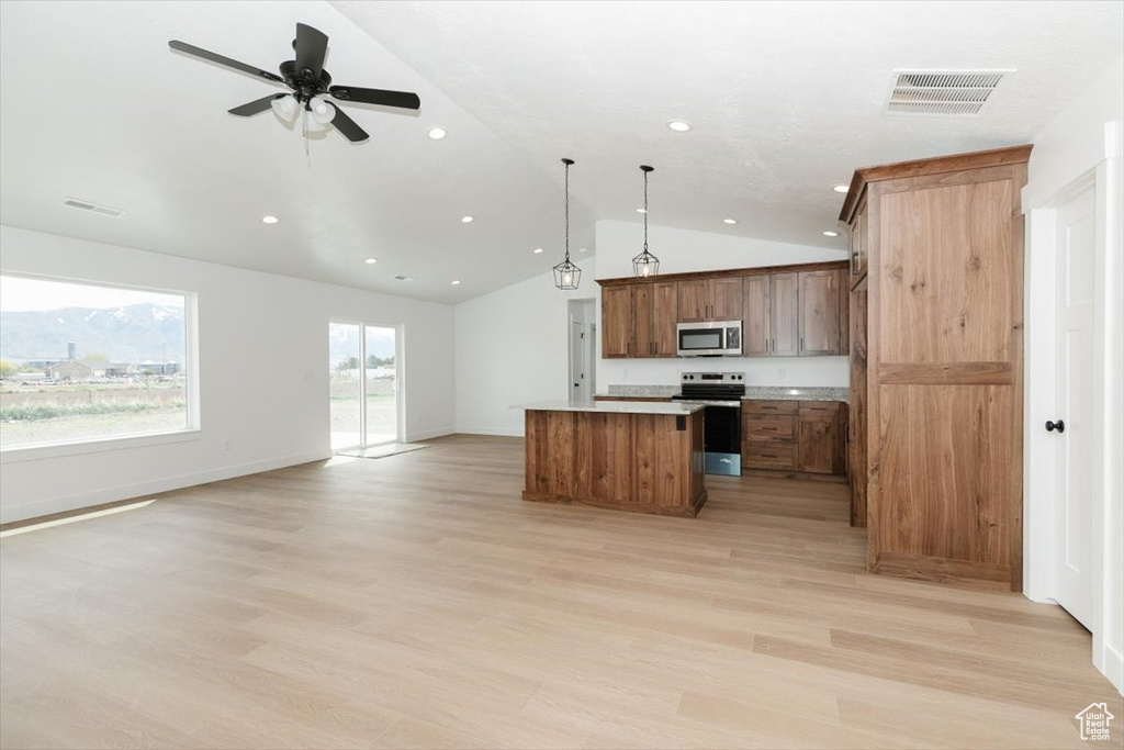 Kitchen with visible vents, a center island, vaulted ceiling, open floor plan, and stainless steel appliances