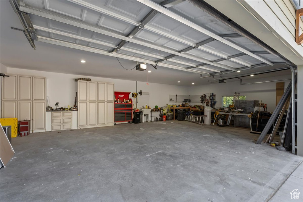 Garage with a workshop area and a garage door opener