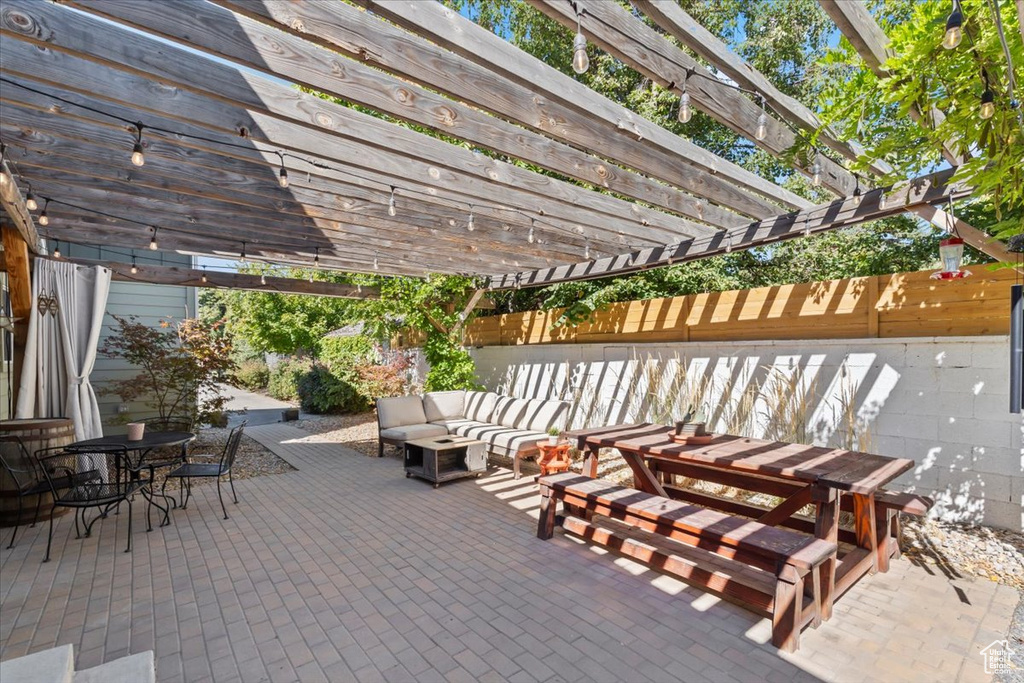 View of patio / terrace with outdoor dining space, an outdoor hangout area, a pergola, and fence
