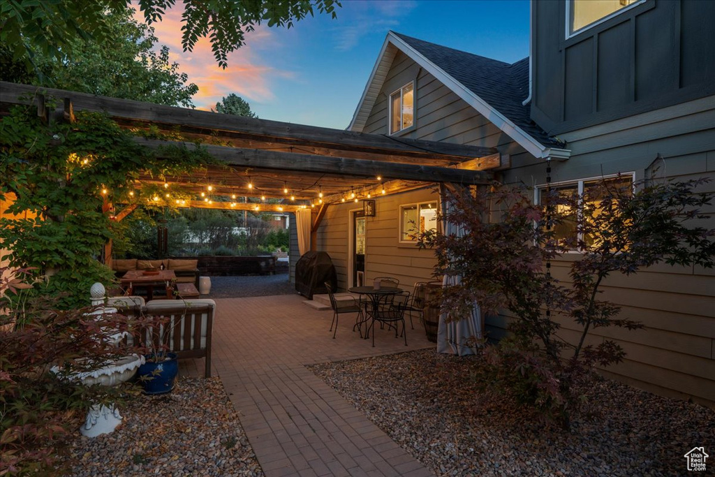 Patio terrace at dusk with a pergola