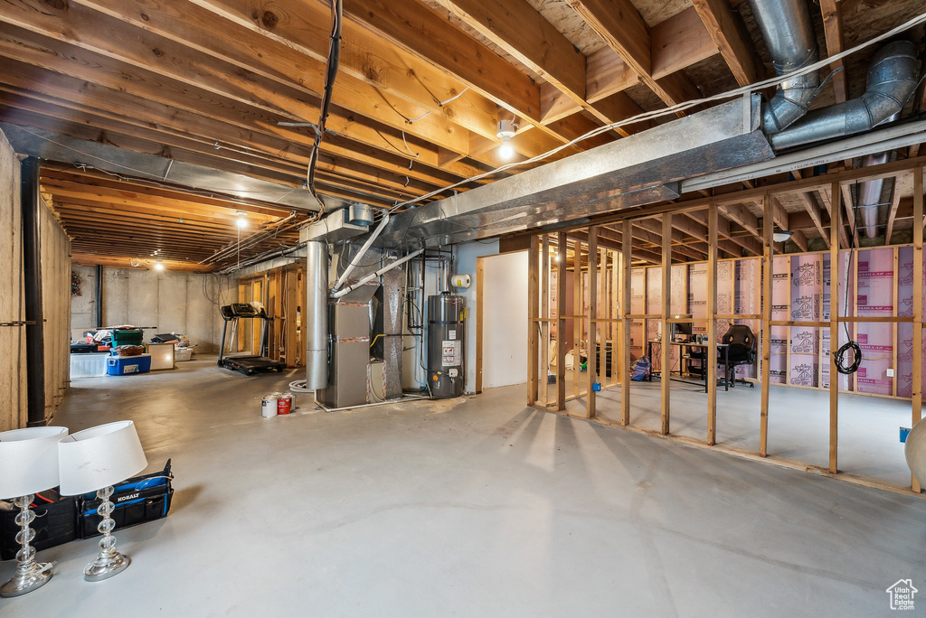 Unfinished below grade area with heating unit and secured water heater