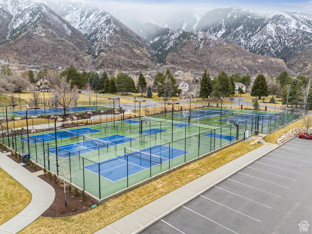 View of tennis court featuring fence and a mountain view