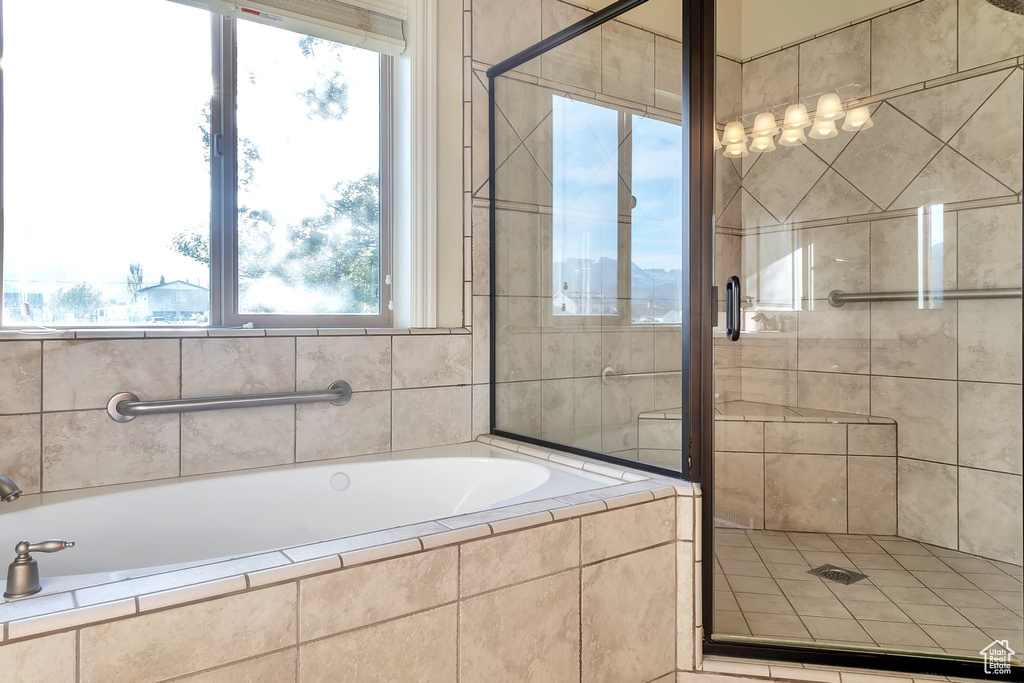 Bathroom featuring a shower stall and a bath