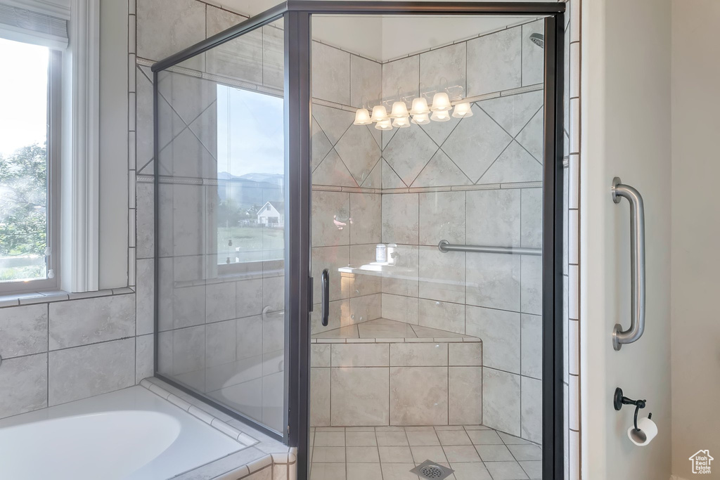 Bathroom featuring a stall shower and a bathtub