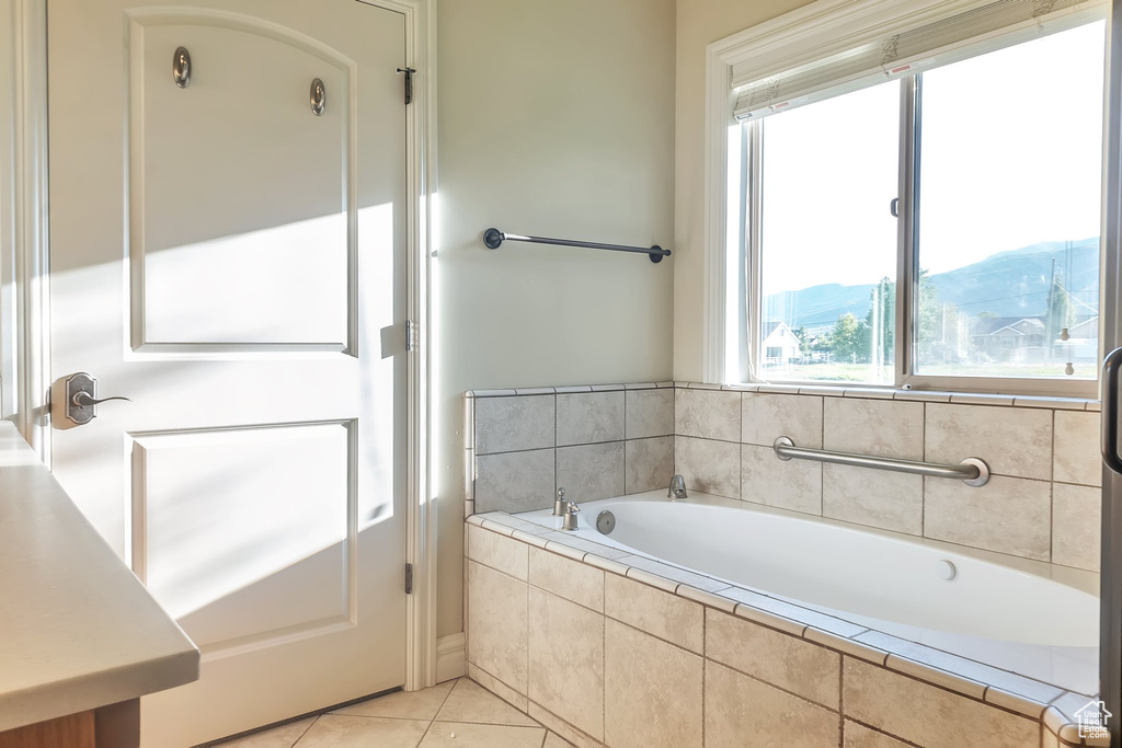 Bathroom featuring a bath and tile patterned floors