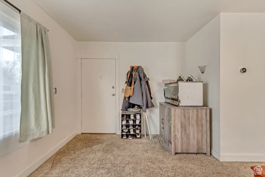 Interior space with baseboards and carpet