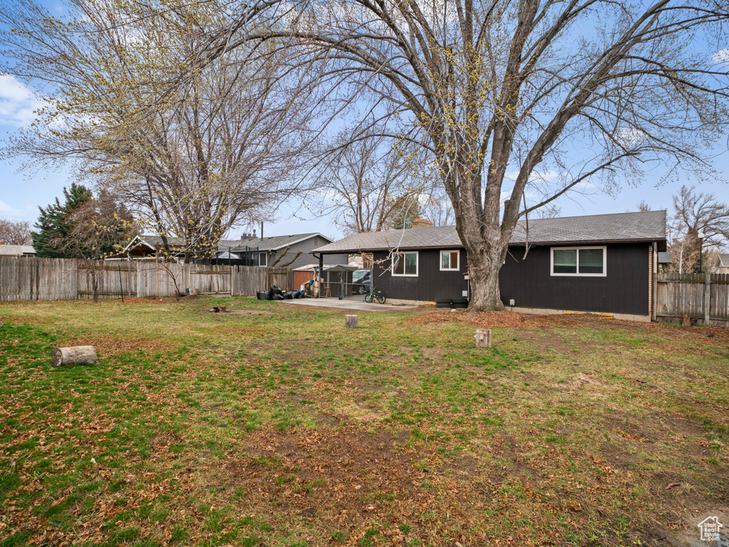 View of yard with a fenced backyard and a patio