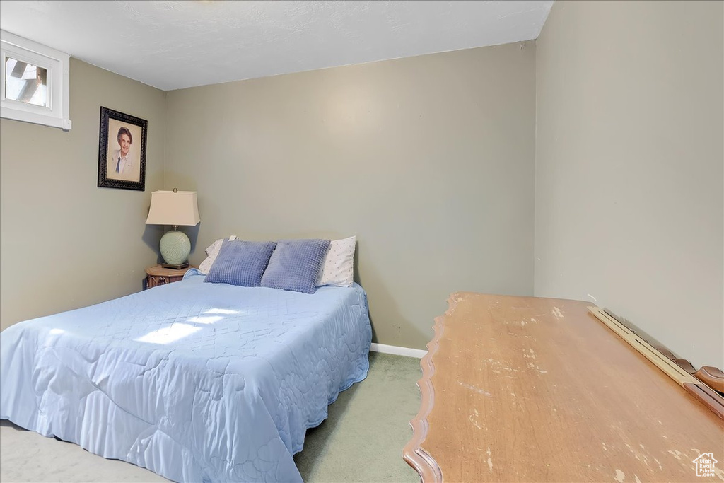 Bedroom with baseboards and carpet