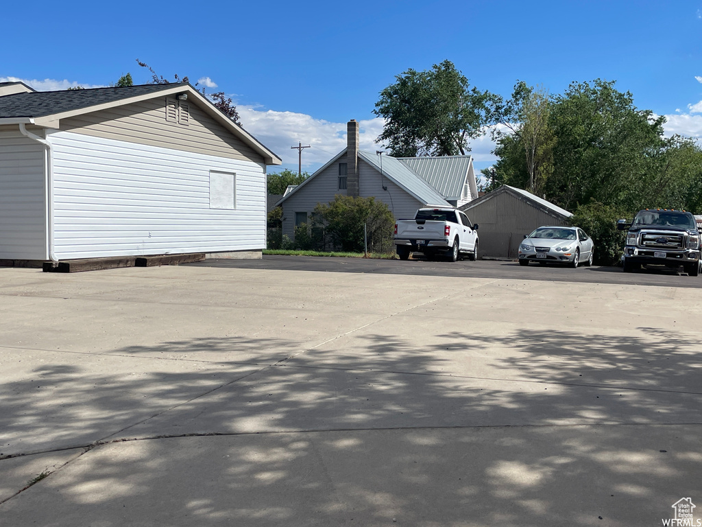 View of side of property featuring uncovered parking