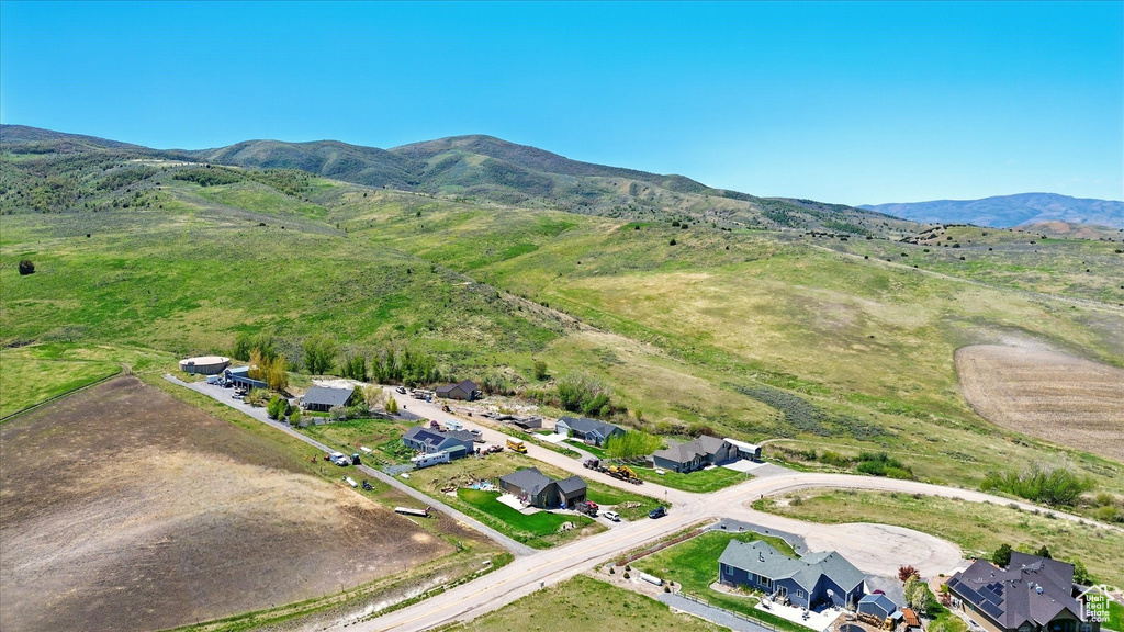 Aerial overview of property's location with mountains and nearby suburban area