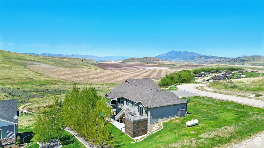 View of subject property with a mountain backdrop