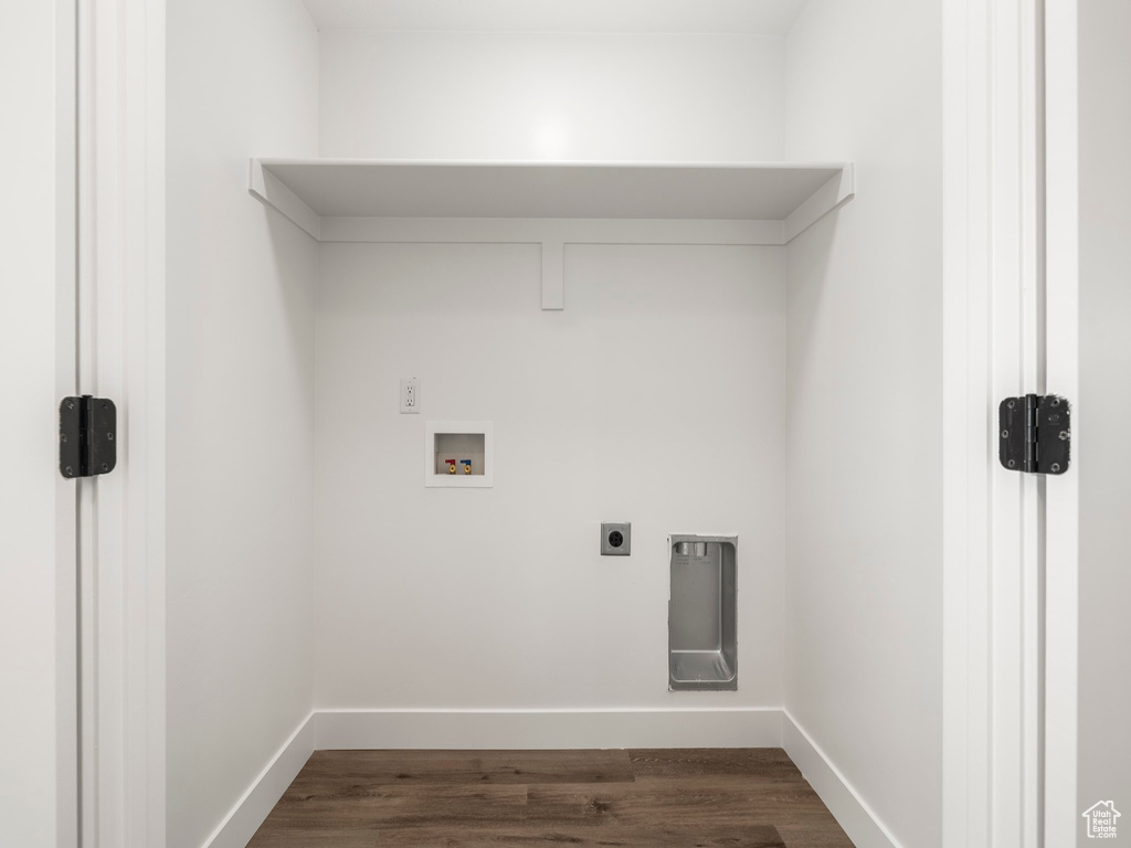 Laundry area with baseboards, laundry area, hookup for a washing machine, dark wood-style floors, and electric dryer hookup