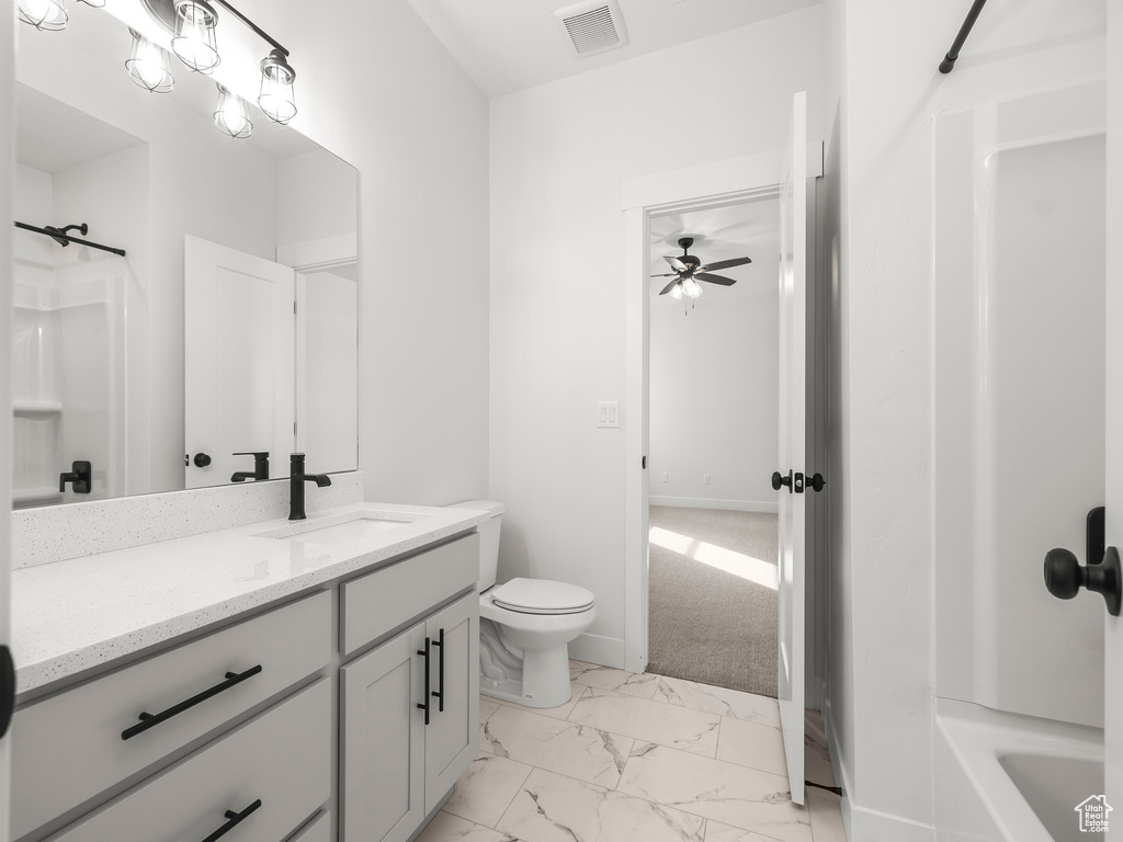 Full bathroom with visible vents, toilet, marble finish floor, a ceiling fan, and vanity