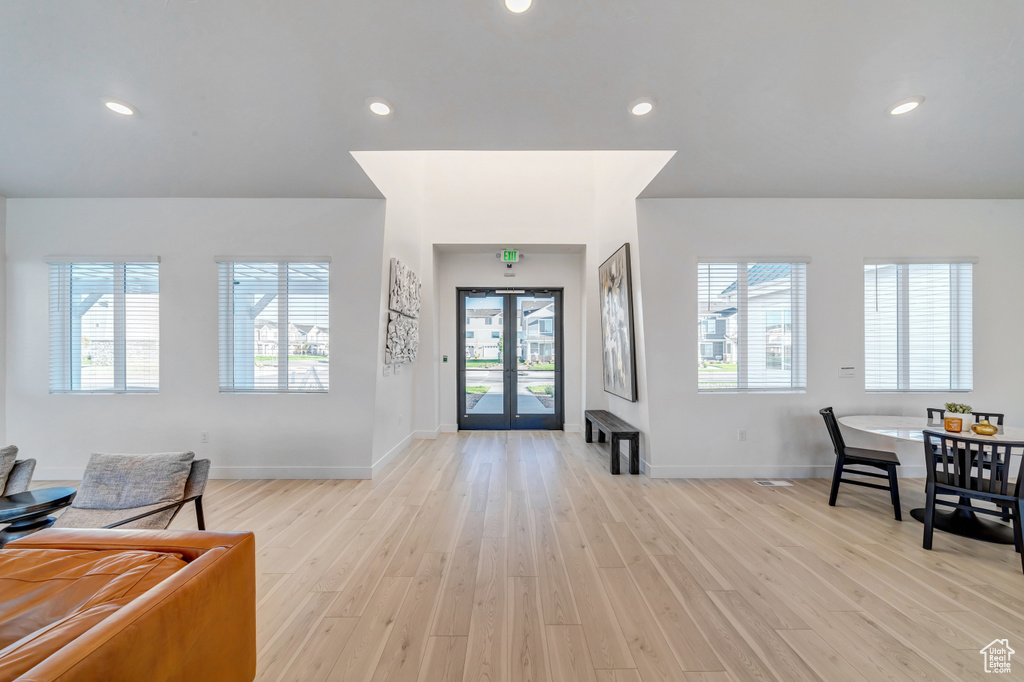 Entrance foyer with recessed lighting, plenty of natural light, and light wood-style flooring
