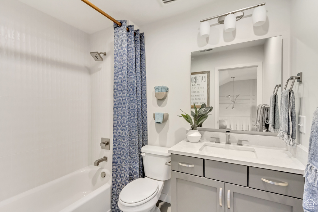 Full bath featuring vanity, shower / bath combination with curtain, and toilet