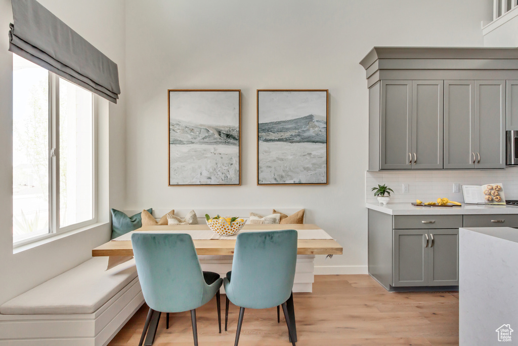 Dining space with baseboards, breakfast area, and light wood-style floors