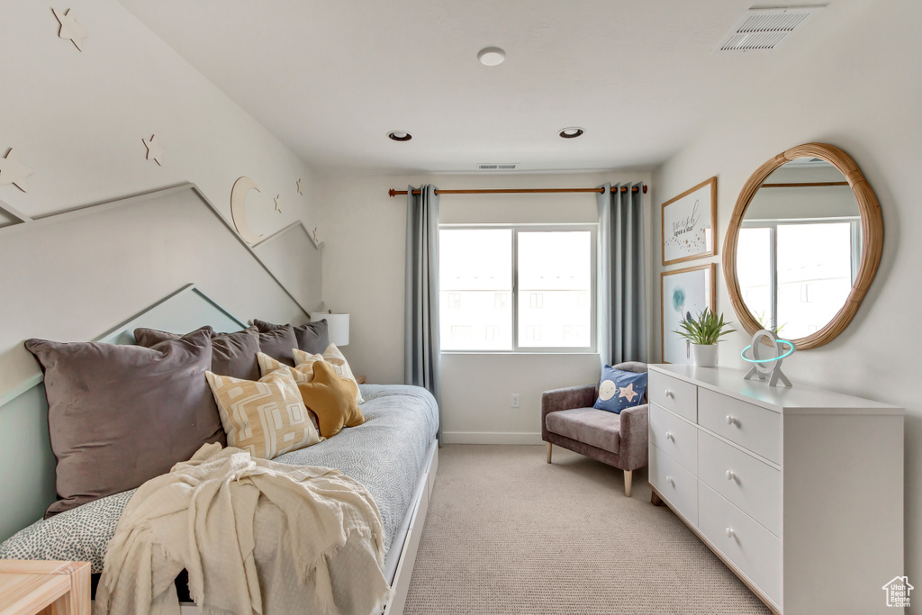 Bedroom featuring visible vents, baseboards, and light colored carpet