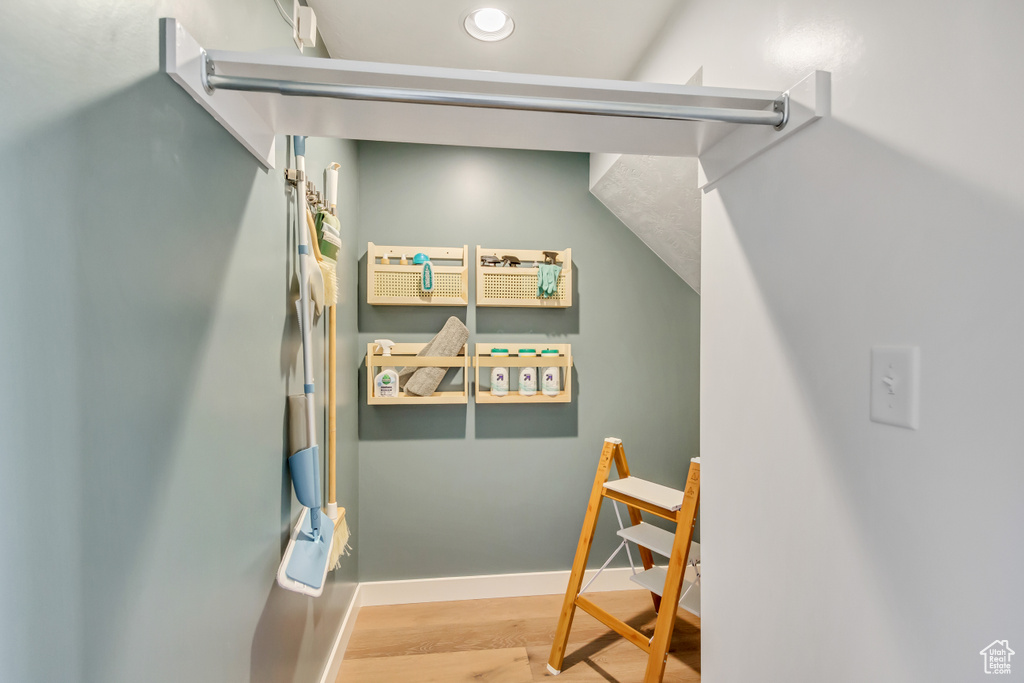 Stairway with baseboards and wood finished floors