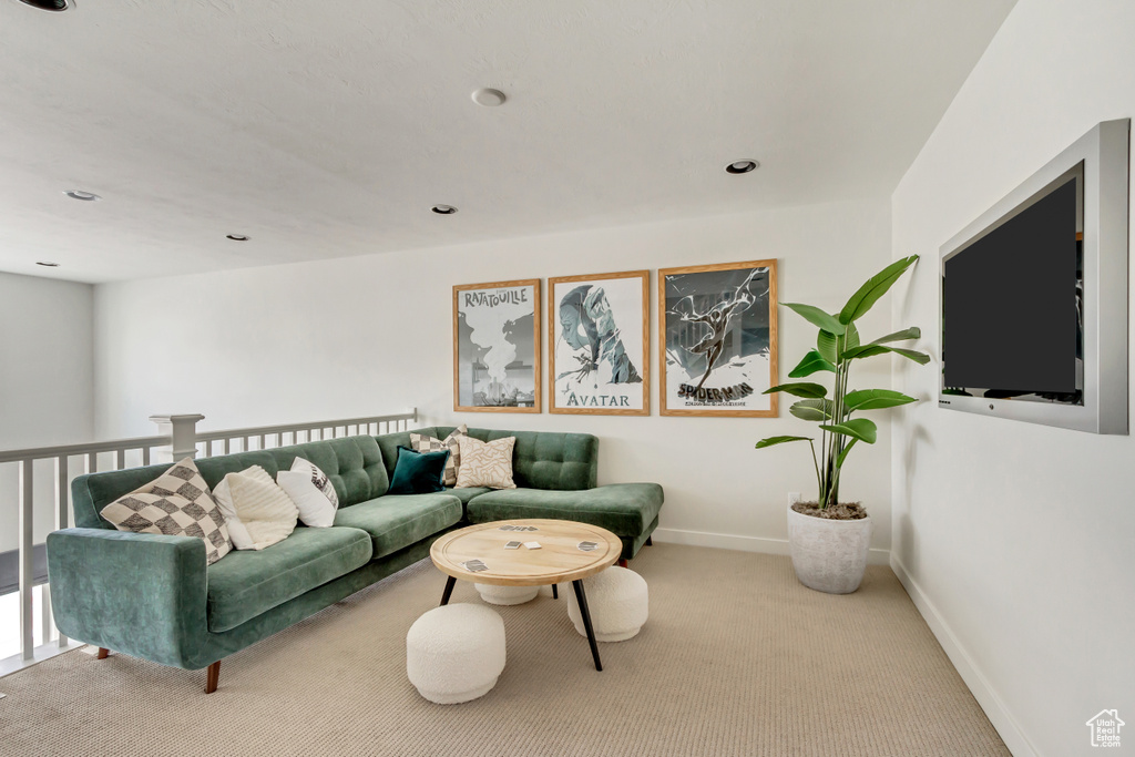 Carpeted living room with recessed lighting and baseboards