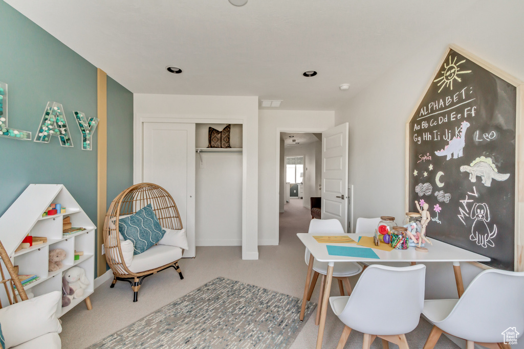 Carpeted dining space with baseboards