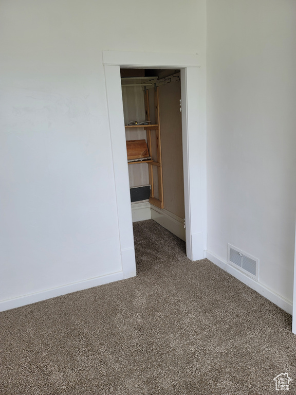 Unfurnished room with carpet flooring and baseboards