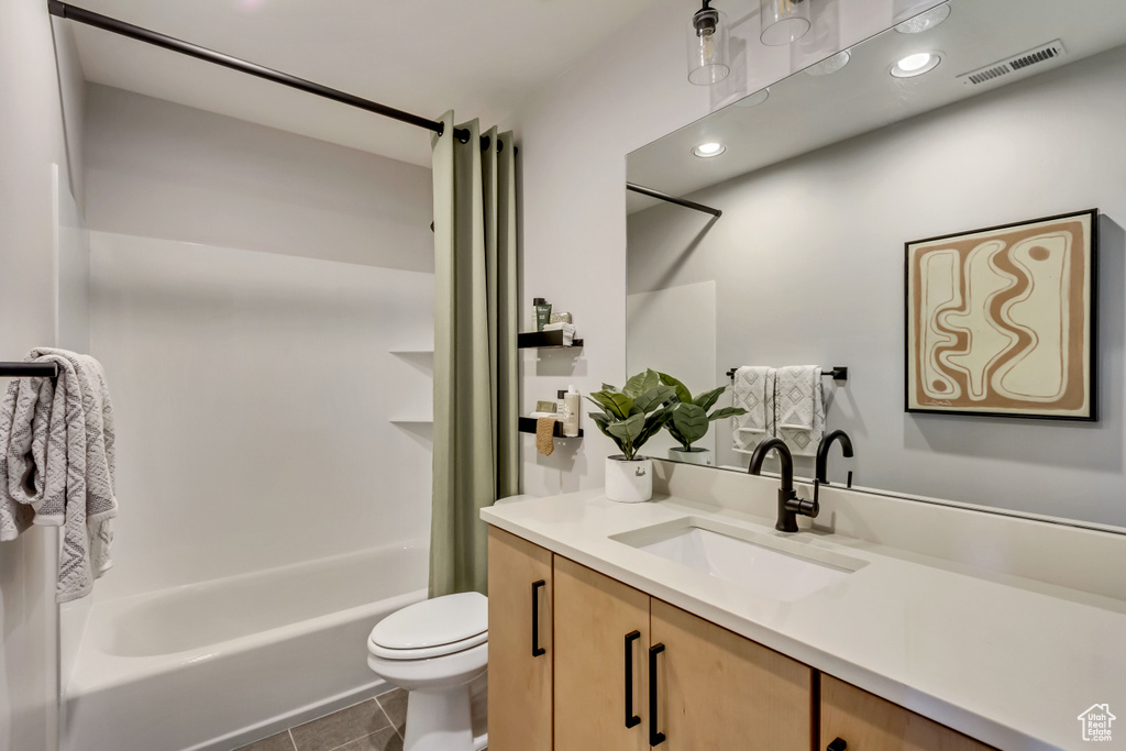 Full bath with visible vents, toilet, tile patterned flooring, shower / bath combination with curtain, and vanity