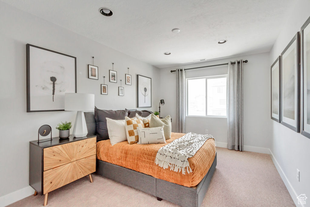 Bedroom with recessed lighting, baseboards, and light carpet