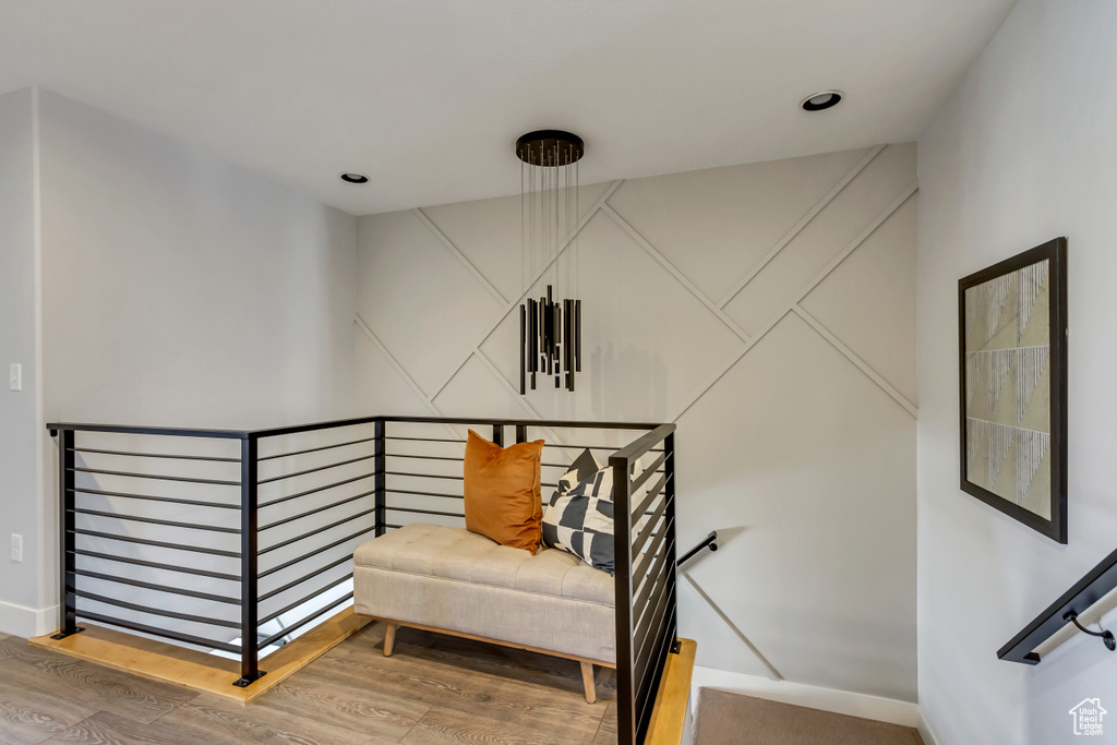 Staircase with recessed lighting, wood finished floors, and baseboards