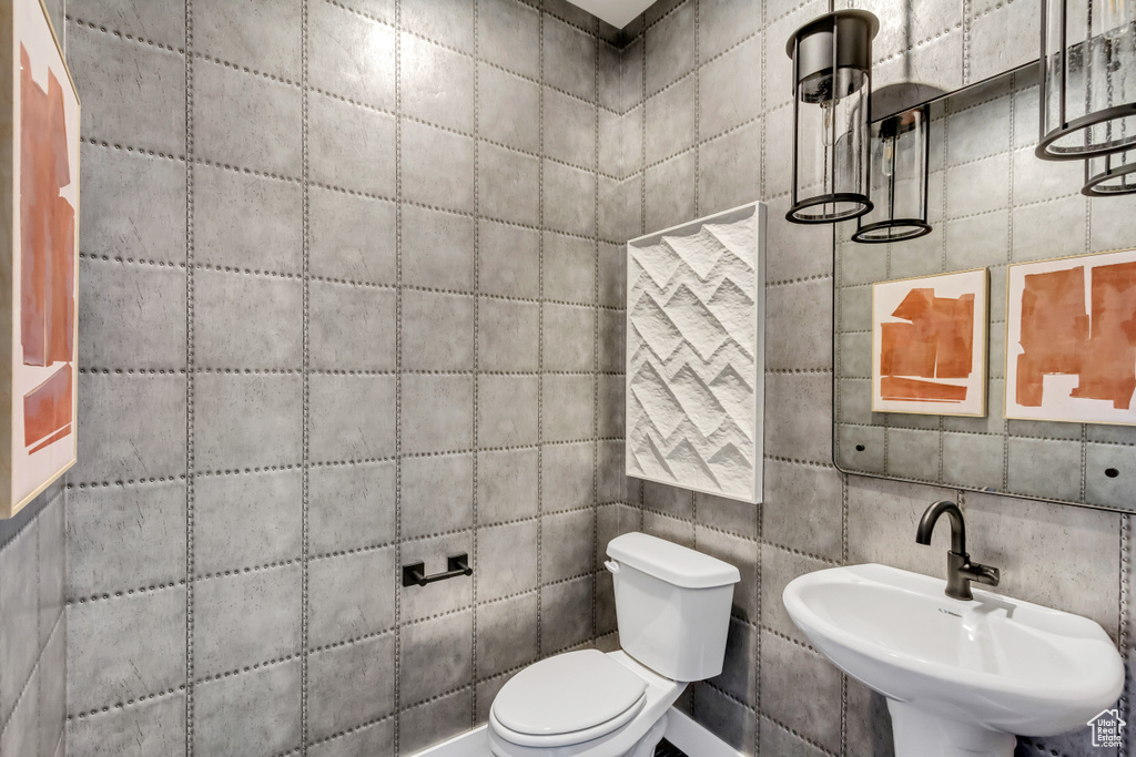 Half bathroom featuring a sink and toilet