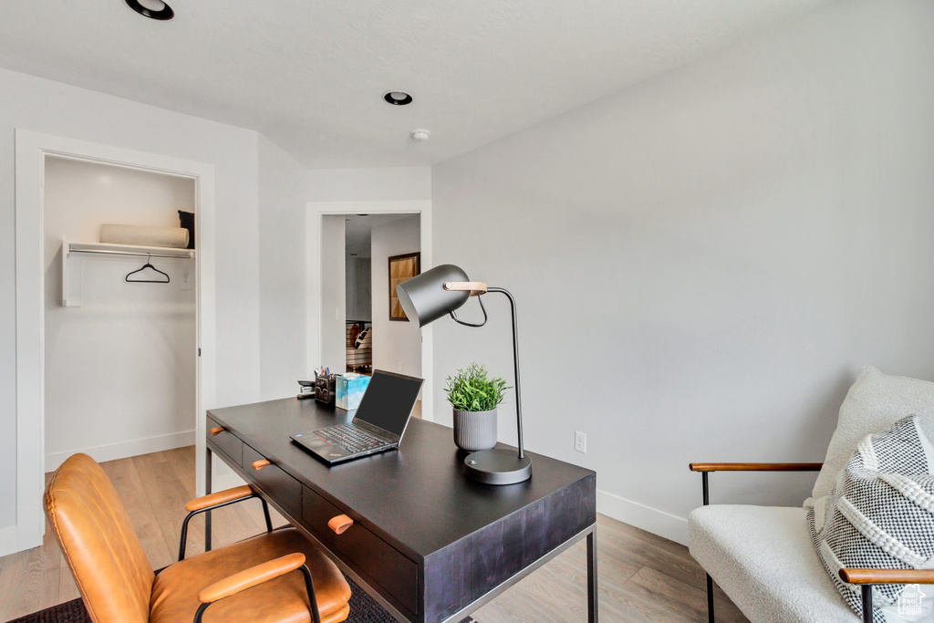 Home office with baseboards and light wood finished floors