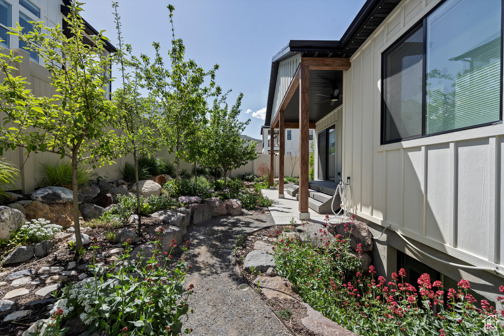 Fenced backyard with a ceiling fan