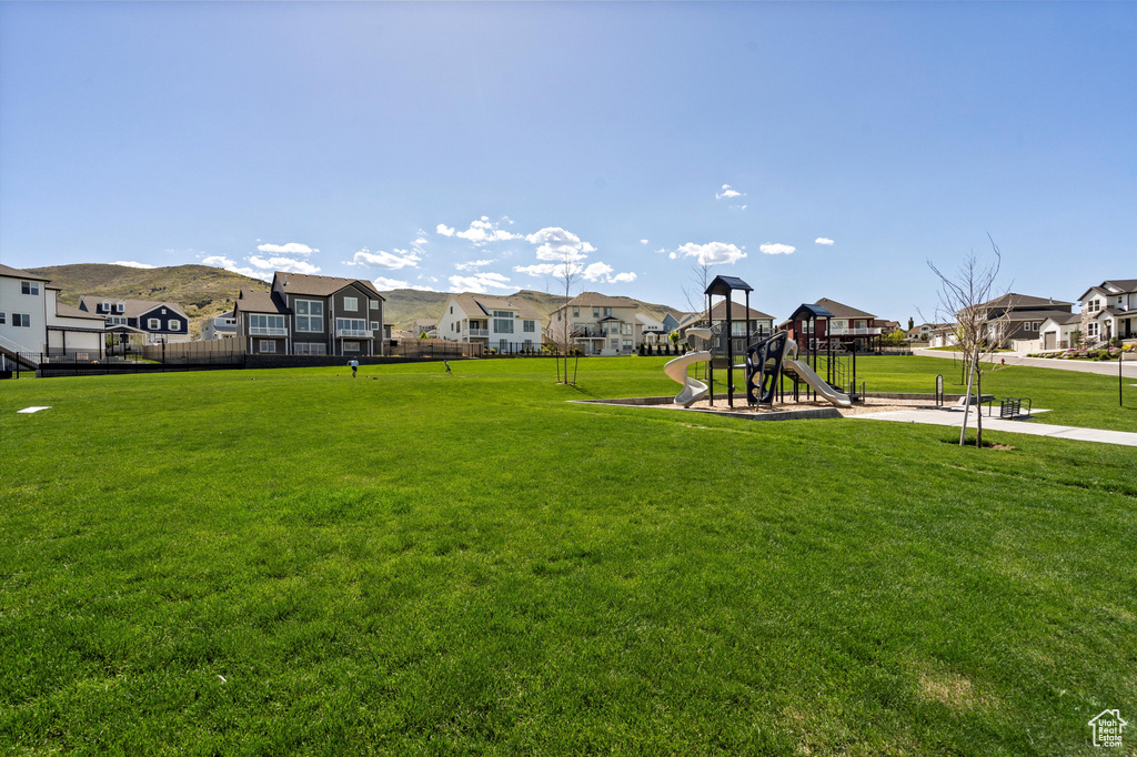 Community play area featuring a residential view and a yard