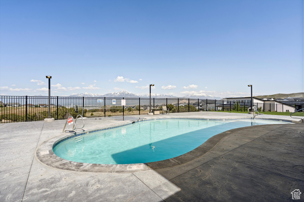Community pool with fence and a patio