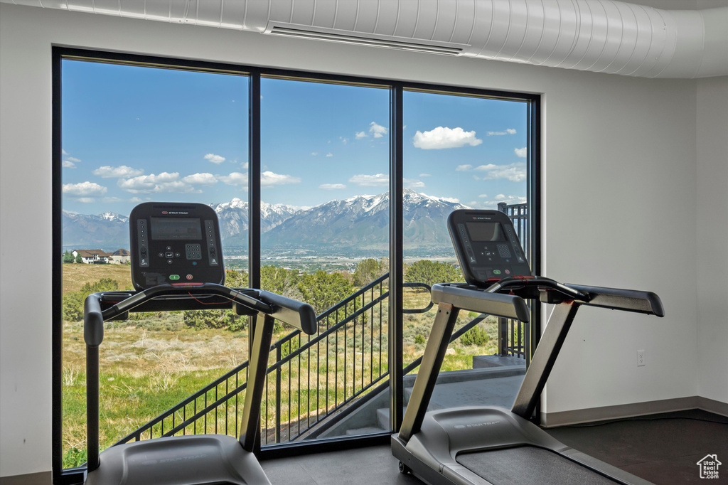 Gym featuring a mountain view and healthy amount of natural light