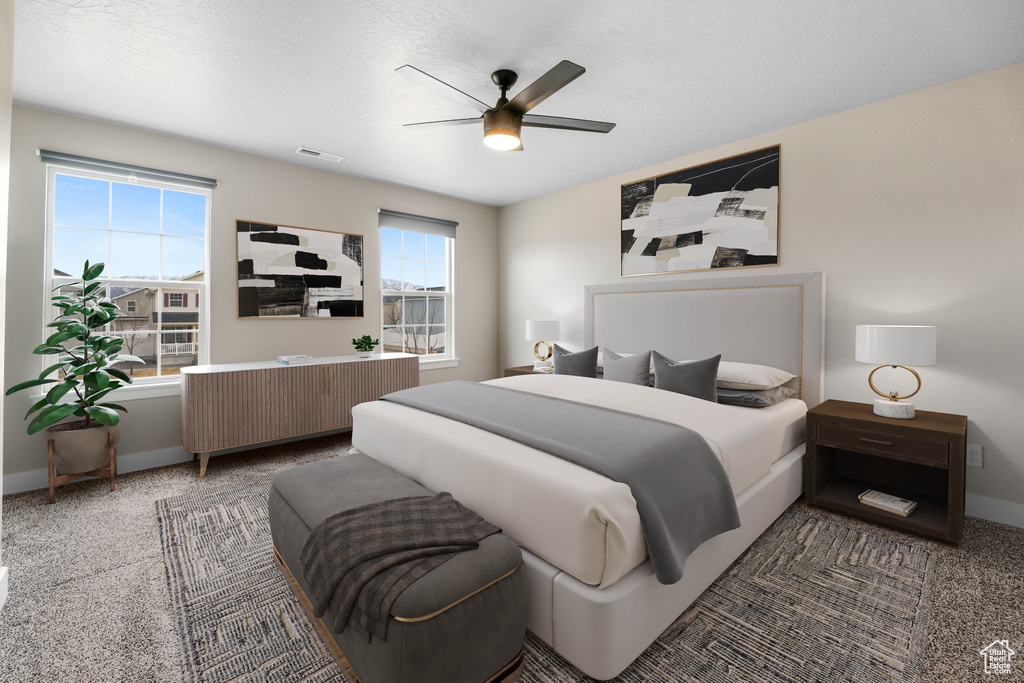 Bedroom with baseboards, radiator heating unit, and a ceiling fan