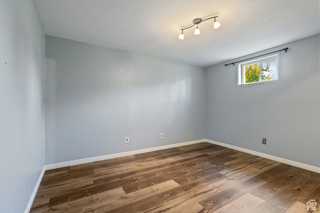 Empty room featuring baseboards and wood finished floors