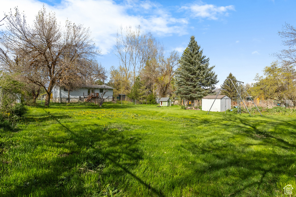 View of yard with a shed and an outbuilding
